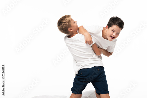 two brothers having fun while imitating fighting isolated on white