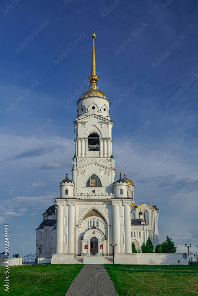 Fototapeta premium Dormition Cathedral bell tower, with blue sky and white clouds, Vladimir, Russia