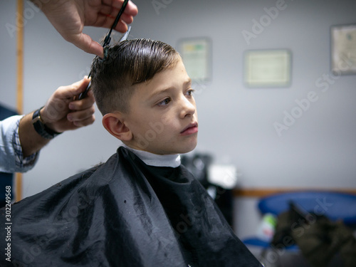 6 year old boy having a hair cut at the hairdresser
