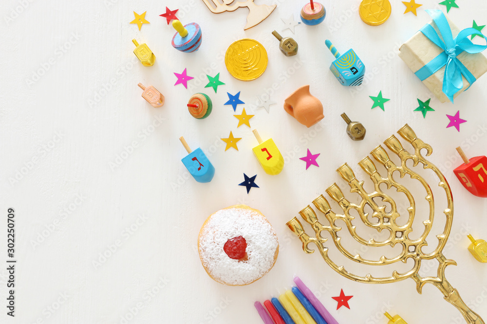 religion image of jewish holiday Hanukkah background with menorah (traditional candelabra), spinning top and doughnut