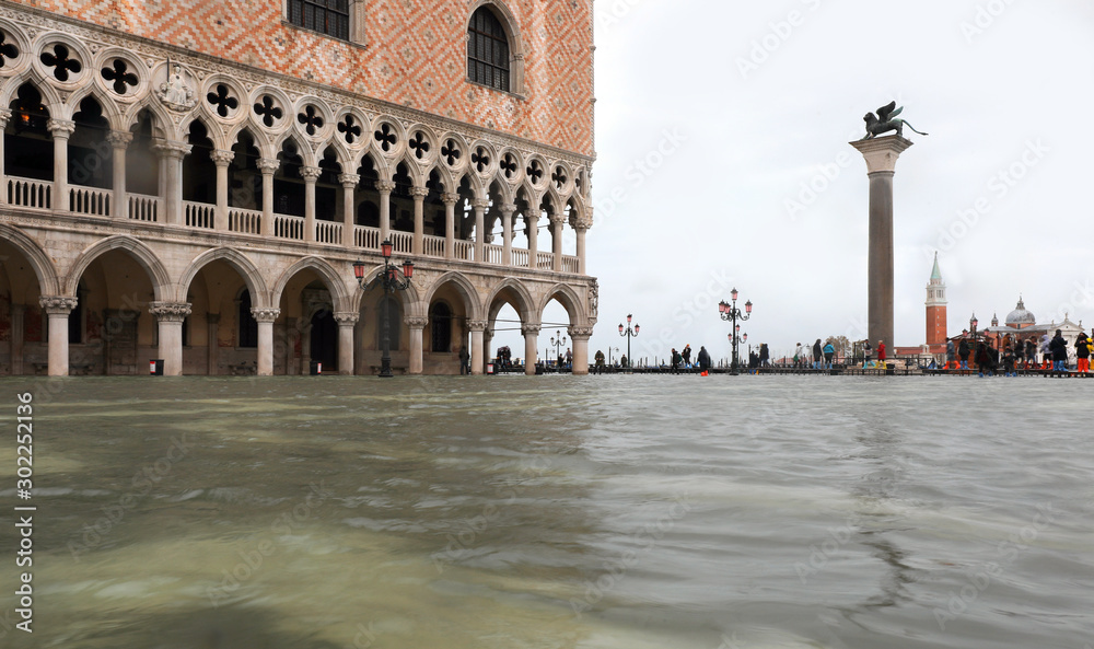 Palazzo Ducale in Venice during the high tide and the pedestrian