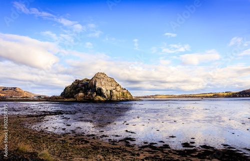 Beautiful Dumbarton Rock by a lake in Scotland photo