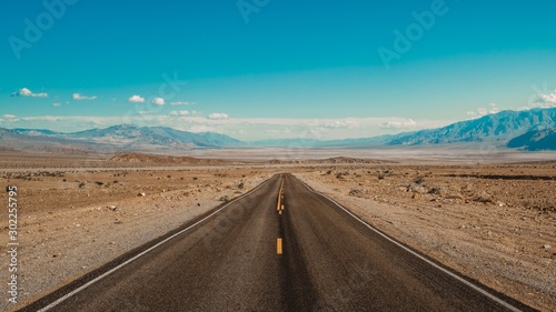 Eye-level shot of a road in the desert of Death Valley, California