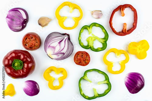 Garlic, sweet salad pepper sliced ​​in circles of different colors isolated on a white background.