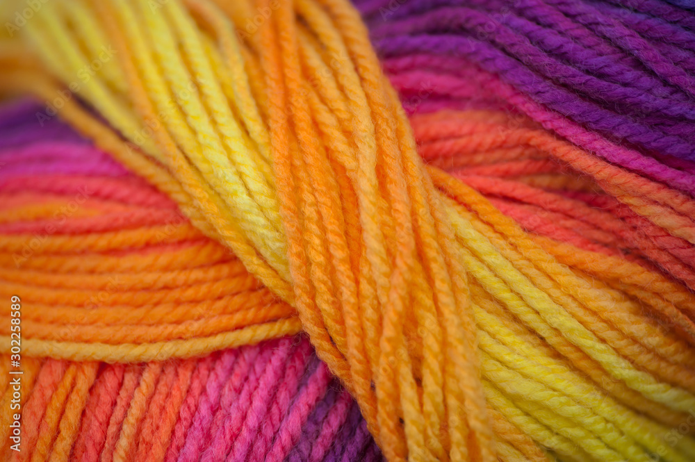 Abstract of skein of rainbow vivid colored acrylic threads in a roll with selective focus Abstract of skein of rainbow vivid colored acrylic threads in a roll with selective focus