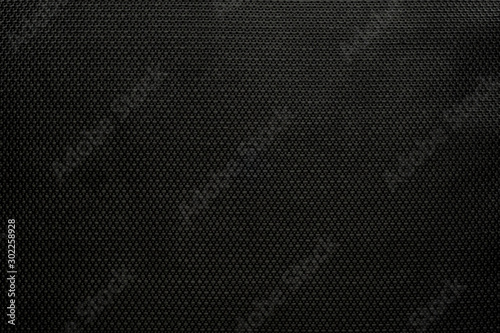 The background dense black modern durable fabric with a pronounced texture pattern