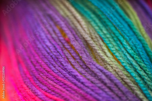 Skein of vivid rainbow colored acrylic threads in free placement background photo