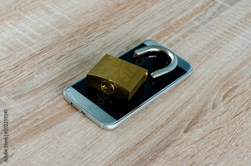 Wallpaper Mural Broken padlock on a broken smartphone, concept for Internet and technology security breach or data theft Torontodigital.ca