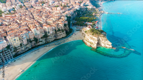 Tropea town and Tyrrhenian Sea beach with Sanctuary church of Santa Maria dell Isola - Panorama with colorful buildings and the church on top of rocks - Vibo Valentia, Calabria, Southern Italy photo