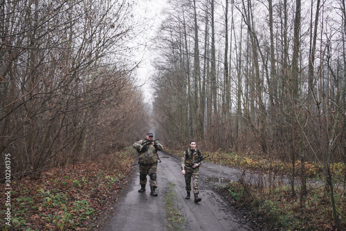 Russian military patrolling the forest as part of a military operation, war game concept