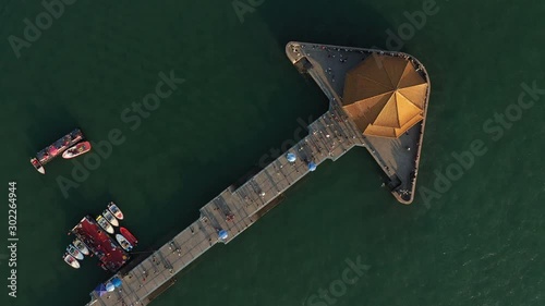 Aerial view of beautiful classic Chinese pavilion in Qingdao, connected to the city by a pedestrian walkway, travel and tourism in China photo
