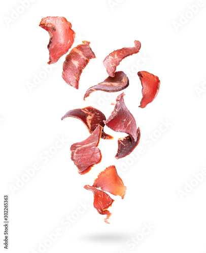 Beef jerky pieces in the air on a white background