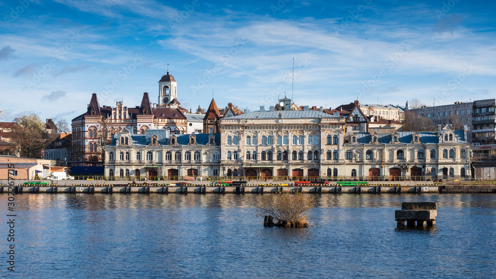 Panorama of the embankment with ancient beautiful buildings of the city of the middle-century city of Vyborg in Russia on an autumn sunny day