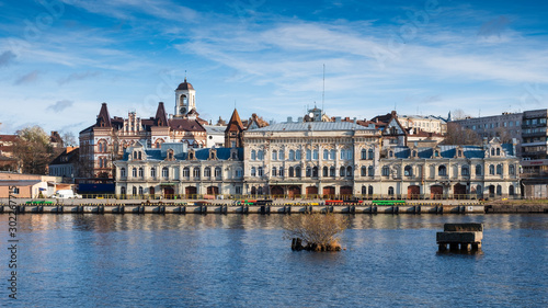 Panorama of the embankment with ancient beautiful buildings of the city of the middle-century city of Vyborg in Russia on an autumn sunny day