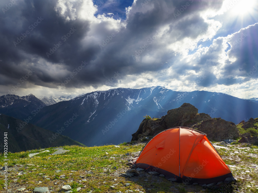 Camping tent in the mountains on a cloudy day.