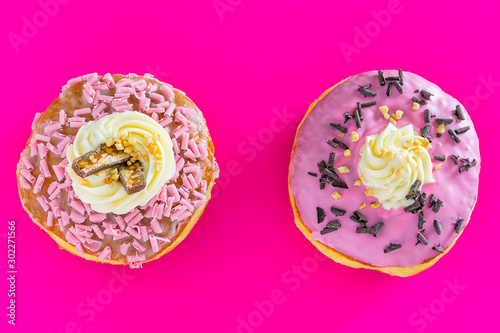 two donuts on pink background