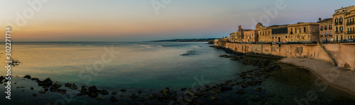 Panoramic view of the seafront of the Ortigia island in the province of Syracuse at early morning at sunrise, Sicily, south Italy