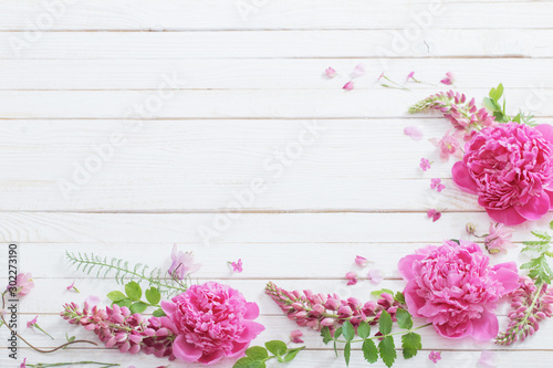 pink beautiful flowers on white wooden background