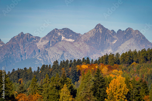 Wide view of beautiful autumn landscape with High Tatra Mountains in background, Slovakia..