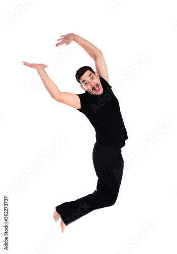 Casual man in black jumping of joy