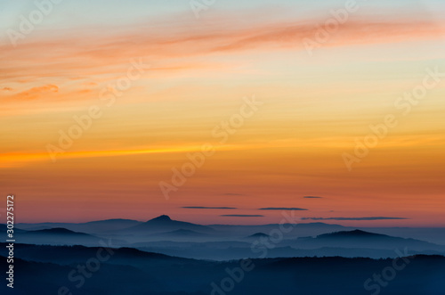 Dramatic sunrise over beautiful mountain peaks. Decinsky Sneznik, Czech republic