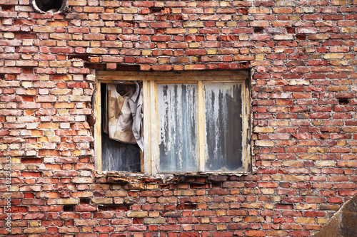 Old broken window on brick wall