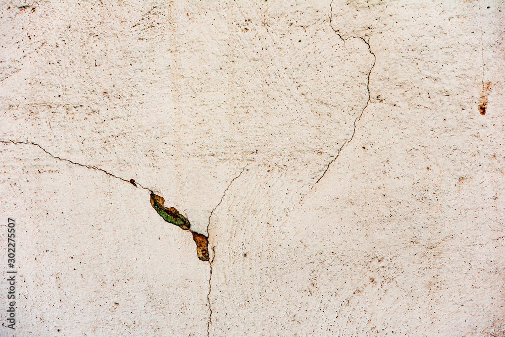 Texture of a concrete wall with cracks and scratches which can be used as a background Texture of a concrete wall with cracks and scratches which can be used as a background