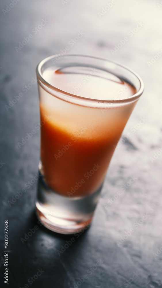 Cool Vodka with tomato juice in a short glass. Cool Vodka with tomato juice in a short glass.