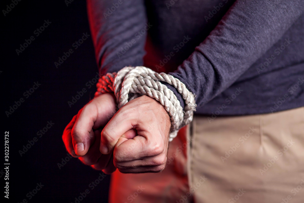 Man with bound hands. People violence and criminal concept