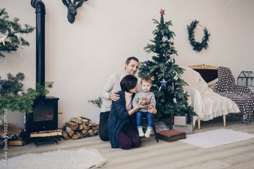 happy family in a decorated Christmas apartment on the eve of the new year