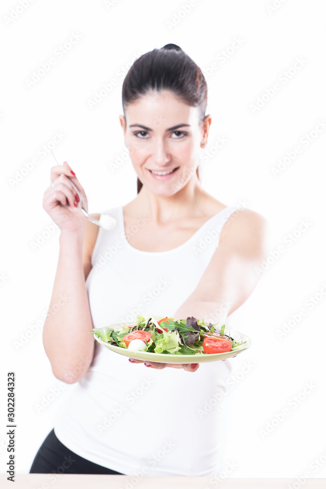 Young woman eating a bowl of healthy organic salad Young woman eating a bowl of healthy organic salad