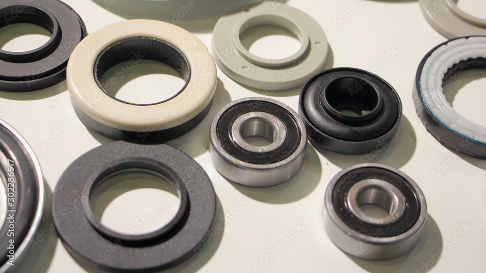 A lot new bearings and o-rings on white background, car parts backdrop texture A lot new bearings and o-rings on white background, car parts backdrop texture