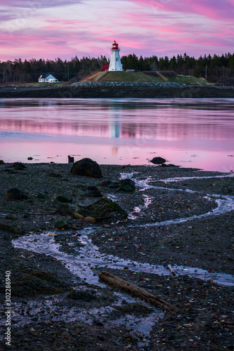 Dramatic pink sky at sunset over Mulholland Lighthouse seen from Maine photo