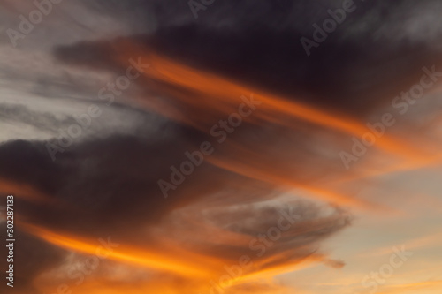 dramatic sky with Spiral clouds. oranges and yellow fill the picture with color