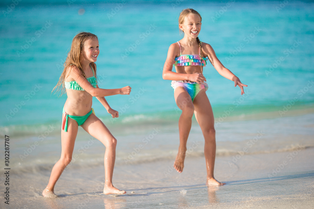 Kids have a lot of fun at tropical beach playing together Kids have a lot of fun at tropical beach playing together