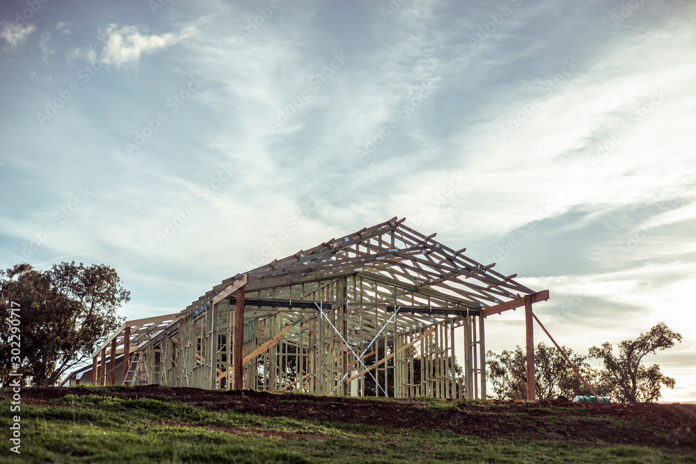 House frame on construction site stands on hill as farm gets build House frame on construction site stands on hill as farm gets build