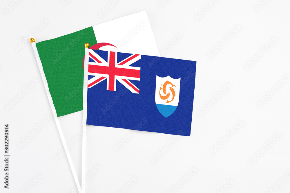 Anguilla and Algeria stick flags on white background. High quality fabric, miniature national flag. Peaceful global concept.White floor for copy space.