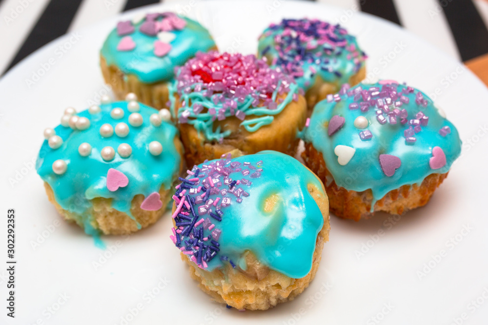 Homemade cupcakes with colorful icing on a plate Homemade cupcakes with colorful icing on a plate