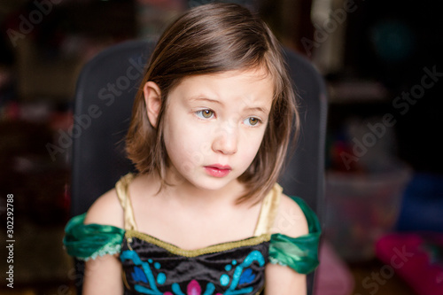 Wallpaper Mural A little girl in a princess costume sits thoughtfully in a chair Torontodigital.ca