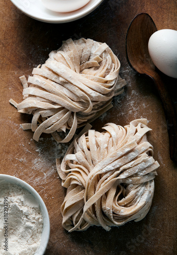 Homemade fresh pasta rolled and drying on cutting board photo