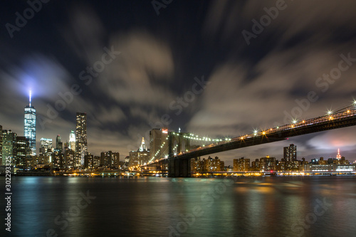 Manhattan skyline with Freedom Tower and Brooklyn Bridge at night. photo