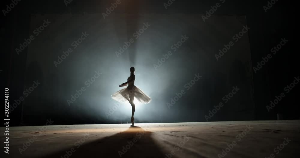 Creative female choreographer setting a ballet performance, dancing and doing various moves on spotted stage - arts concept 4k footage
