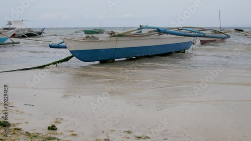 Daytime shot with overcast sky of small fishing boats in the Philippines. photo