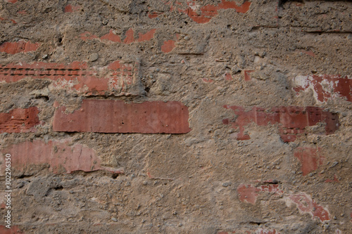 Old brick wall, cracked cinder block