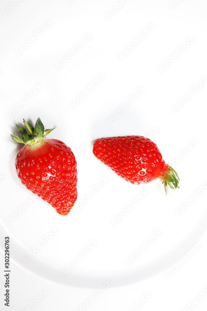 Fresh strawberries isolated on the white plate.