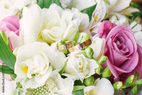 Beautiful gold wedding rings in wedding colors  close-up. Wedding accessories