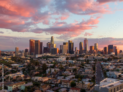 Drone shot from above of downtown Los Angeles city skyline and skyscraper buildings during golden hour