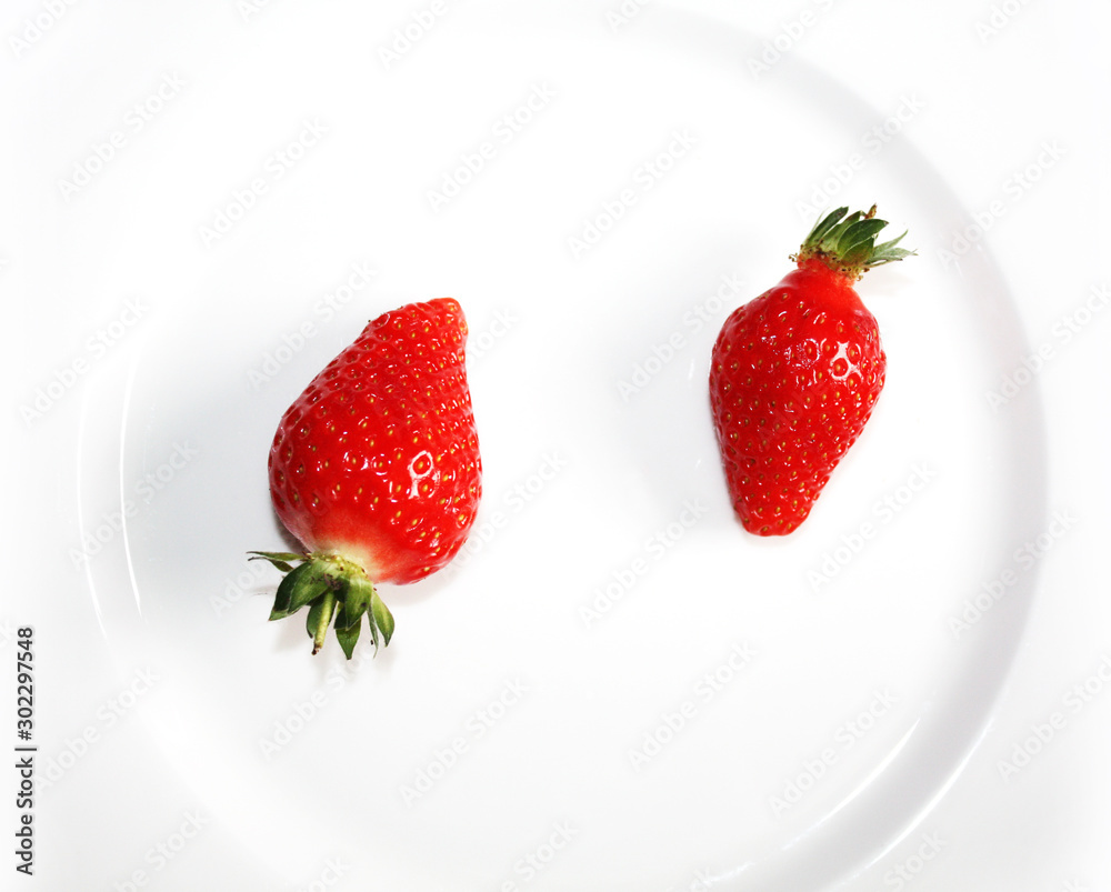 Fresh strawberries isolated on the white plate.