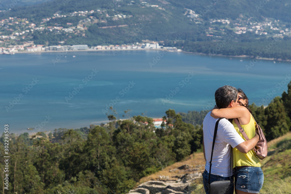 Fototapeta premium couple kissing on vacation in Galicia, in front of Miño