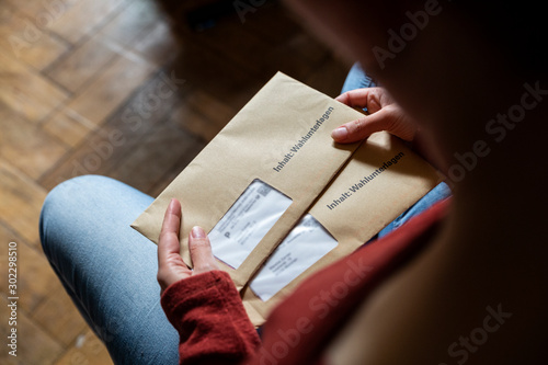 Female elector holding documtents for the postal vote in her hands photo